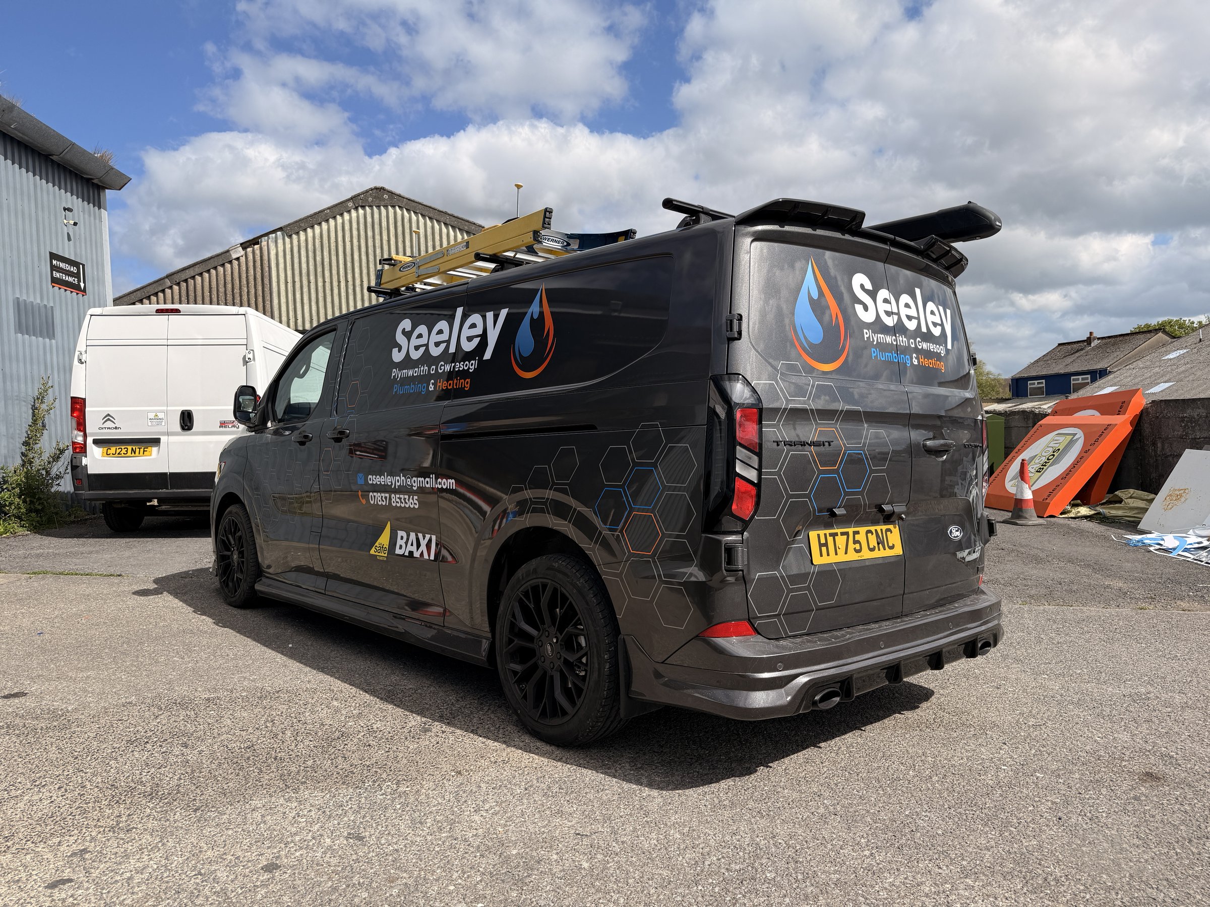 Seeley Plumbing and Heating vehicle graphics rear three-quarter view
