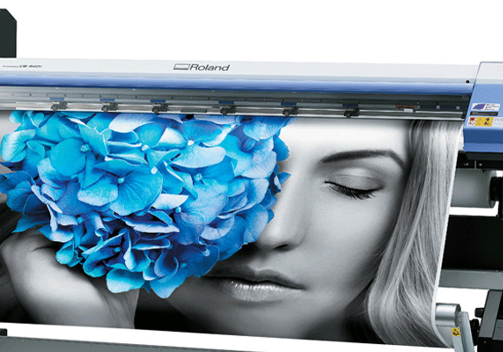 Roland VersaCamm large-format print and cut machine used for graphics production