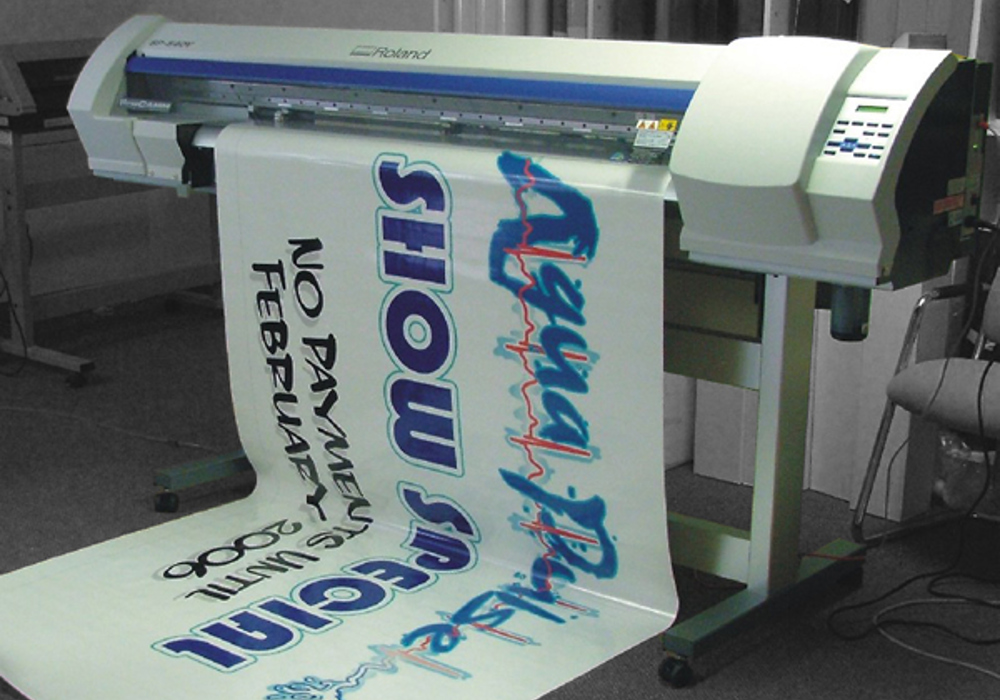 Large-format printer producing a printed Eagle Signs graphic