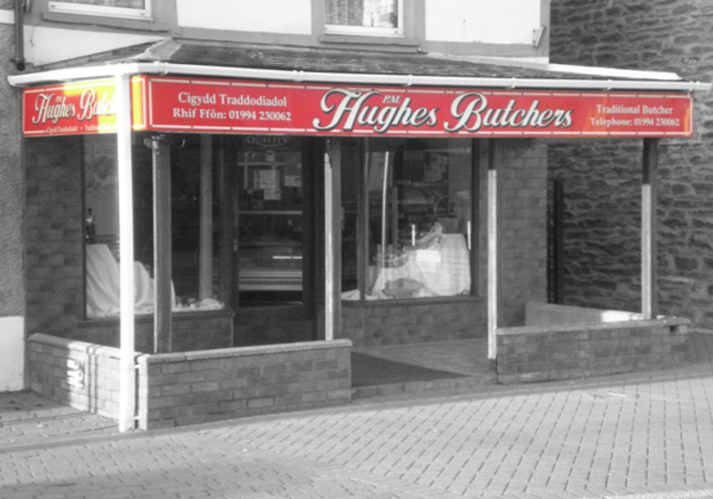 Hughes Butchers storefront with fascia signage above display windows