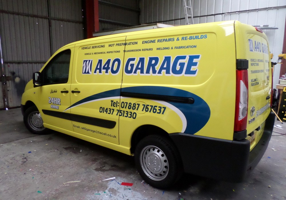 Bright yellow commercial van with high-impact A40 Garage vehicle graphics
