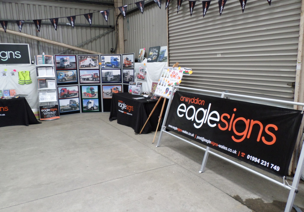 Eagle Signs exhibition display showing project photographs and printed material