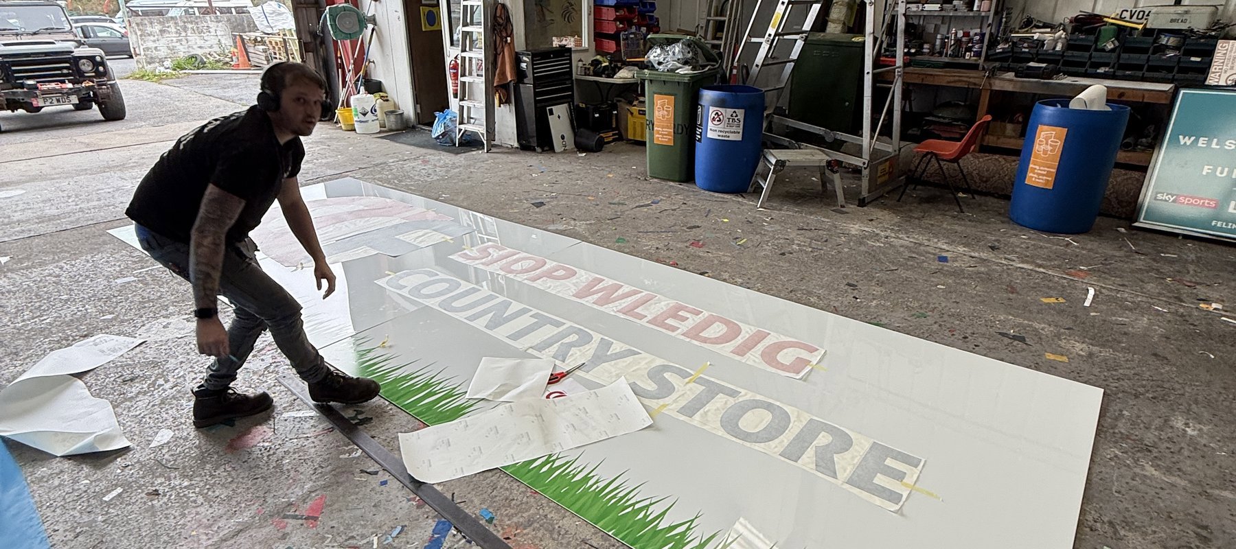 Eagle Signs workshop team producing a large business sign